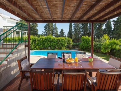 Covered dining table by the pool