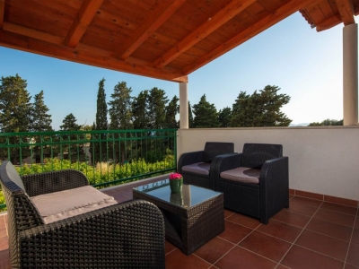 Covered first floor terrace with garden furniture for relaxing