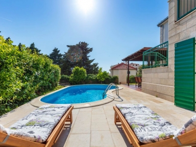Back yard with deckchairs and pool