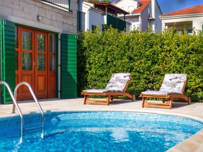 Back yard with deckchairs and pool